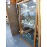 A VINTAGE DUDLEY AND CO OAK FRAMED GLASS DOOR OUTFITTERS CABINET.