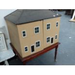 AN ANTIQUE COUNTRY HOUSE DOLL'S HOUSE ON STAND.