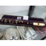 AN IVORY AND ROSEWOOD CASED FLUTE.
