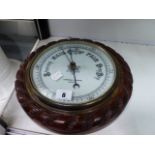 AN OAK FRAMED ANEROID BAROMETER.