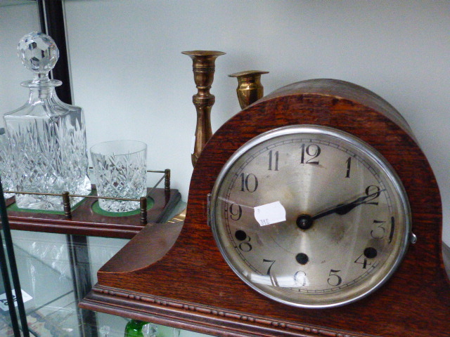 A DECANTER STAND WITH GLASS, A PAIR OF CANDLESTICKS AND A MANTLE CLOCK.