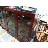 A SMALL MAHOGANY GLAZED BOOKCASE.