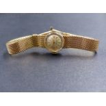 A 9CT GOLD LADIES MANUAL WOUND MOVADO WATCH ON A MESH STYLE BRACELET, GROSS WEIGHT 18.9GRMS.