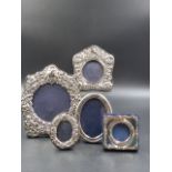 A GROUP OF FIVE SILVER HALLMARKED PHOTO FRAMES WITH BLUE VELVET BACKS LARGEST MEASUREMENT 9.5CMS