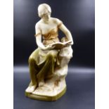 A ROYAL DUX BOHEMIAN FIGURE OF A GIRL SEATED ON A ROCK READING A BOOK. H.41CMS.