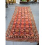 A TRIBAL ORIENTAL RUG OF CAUCASIAN DESIGN. 340 X 147CMS.