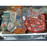 THREE PAIRS OF CHINESE EMBROIDERED SILK SLEEVE PANELS, OTHER CUTS FROM ROBES AND A FLORAL RANK BADGE