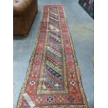 AN ANTIQUE CAUCASIAN RUNNER. 384 X 87CMS.