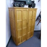 AN OAK ARTS AND CRAFTS STYLE PANELLED TWO DOOR CABINET, HAND MADE BY REPUTE BY AN EX-ROBERT THOMPSON