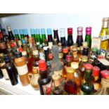A MIXED LOT OF MINIATURE WHISKIES AND OTHER SPIRITS, OVER 100 BOTTLES TOGETHER WITH BABYCHAM,