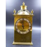 AN ARTS AND CRAFTS STYLE BRASS CASED DESK CLOCK WITH ENGRAVED DECORATION.