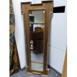 A CARVED GILTWOOD KENTIAN STYLE TRIPLE PLATE OVERMANTLE MIRROR. 50 X 140CMS.