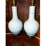 TWO CHINESE CELADON GLOBE AND SHAFT VASES DECORATED IN WHITE WITH DRAGONS ENCIRCLING LINGZHIH