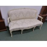 A CARVED AND PAINTED LOUIS XV STYLE SALON SETTEE WITH SHAPED UPHOLSTERED BACK AND SEAT ON CABRIOLE