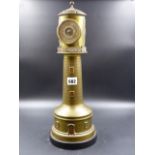 A COPPER INSET BRASS LIGHTHOUSE TIMEPIECE AND ANEROID BAROMETER. H.43CMS.
