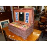 AN ANGLO INDIAN ELABORATELY CARVED HARDWOOD WORK BOX WITH LIFT TOP AND MIRROR BACK ENCLOSING