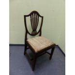 A SET OF SIX CARVED MAHOGANY HEPPLEWHITE STYLE SHIELD BACK DINING CHAIRS.