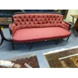 A 19TH.C.EBONISED AND GILT BUTTON BACK LOUIS XVI STYLE SALON SETTEE WITH BRASS CASTORS. W.184CMS.