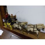 A SCALE MODEL OF A CARRIAGE WITH FIGURES OF A TEAM OF FOUR. L93CMS. W.14CMS.