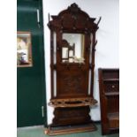 A LATE 19TH.C.CARVED OAK MIRROR BACK HAT / STICKSTAND. W.95 X H.238CMS.