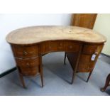 AN ANTIQUE SATINWOOD SHERATON STYLE PAINT DECORATED KIDNEY SHAPED WRITING DESK WITH LEATHER INSET