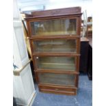 A GOOD OAK GLOBE WERNIKE FIVE TIER GLAZED BOOKCASE WITH DRAWER BASE.