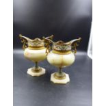A PAIR OF FRENCH CHAMPLEVE MOUNTED ONYX VASES, THE TURQUOISE GROUND SOCLES ON CHAMFERED SQUARE FEET.
