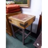 A VINTAGE SQUARE BUTCHER BLOCK MOUNTED ON LATER IRON BASE. H.87 X 60CMS.