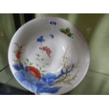 A JAPANESE IMARI BOWL PAINTED WITH BUTTERFLIES AND FLOWERS WITH WOODEN STAND. DIA.24.5CMS.