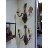 A PAIR OF ANTIQUE GILT NEOCLASSIC STYLE TWIN LIGHT WALL LIGHTS, SCROLL ARMS ISSUE FROM FLOWER FILLED