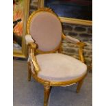 A PAIR OF FRENCH CARVED GILTWOOD LOUIS XVI STYLE SALON ARMCHAIRS WITH OVAL BACKS AND SHAPED SEATS ON