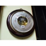 A GERMAN ANEROID BAROMETER IN WALL MOUNTING VARNISH WOOD CASE. DIA.33CMS.