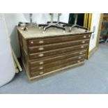 A VINTAGE TWO PART SIX DRAWER PLAN CHEST WITH PANELLED SIDES ON PLINTH BASE. W.150 X D.93 X H.