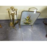 AN ARTS AND CRAFTS DESIGN BRASS FIRE TOOL SET WITH STAND TOGETHER WITH A DECORATED MIRRORED FIRE