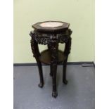 A CHINESE CARVED HARDWOOD OCTAGONAL STAND WITH INSET MARBLE TOP AND CONFORMING CIRCULAR UNDERTIER ON