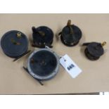 A GRAHAM & CO INVORNES 3 1/5" FISHING REEL, A 3" EXAMPLE AND THREE SMALLER UNSIGNED BRASS REELS. (