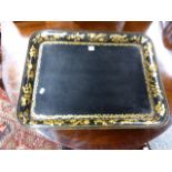 A REGENCY BLACK PAPIER MACHE RECTANGLUAR TRAY WITH GILT FLORAL BORDERS. W.88CMS.