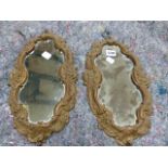 A PAIR OF 19TH.C.CONTINENTAL CARVED ROCOCO STYLE SMALL MIRRORS OF SHAPED FORM. H.37CMS.