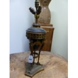 A GILT AND PATINATED BRONZE TABLE LAMP IN THE NEOCLASSICAL TASTE WITH WINGED CARYATID SUPPORTS.