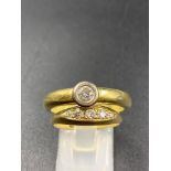 A YELLOW METAL RUB OVER SET DIAMOND SOLITAIRE RING (SIZE T), TOGETHER WITH AN 18CT YELLOW GOLD