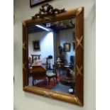 AN ANTIQUE GILT MIRROR IN THE FRENCH TASTE WITH RIBBON CREST. H.66CMS.