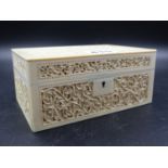 A 19TH.C.INDIAN IVORY RECTANGULAR BOX CARVED IN RELIEF WITH BEAD FRAMED SCROLLING FLOWERING VINES.