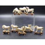 THE EIGHT HORSES OF MU WANG, THE CHINESE IVORIES WITH WOODEN STANDS EACH H.5CMS.