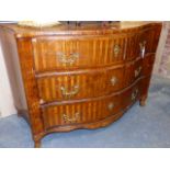 AN ANTIQUE CONTINENTAL PARQUETRY INLAID THREE DRAWER COMMODE OF SERPENTINE FORM WITH CURVED SIDES