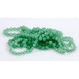 Lot of two Chinese green jade beaded necklaces, measuring 48" and 50" l. Provenance: From a Beverly,