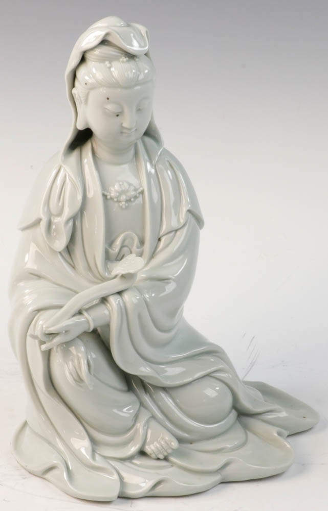 Chinese white porcelain sitting Guanyin figure holding a ruyi, 10 1/2"h.