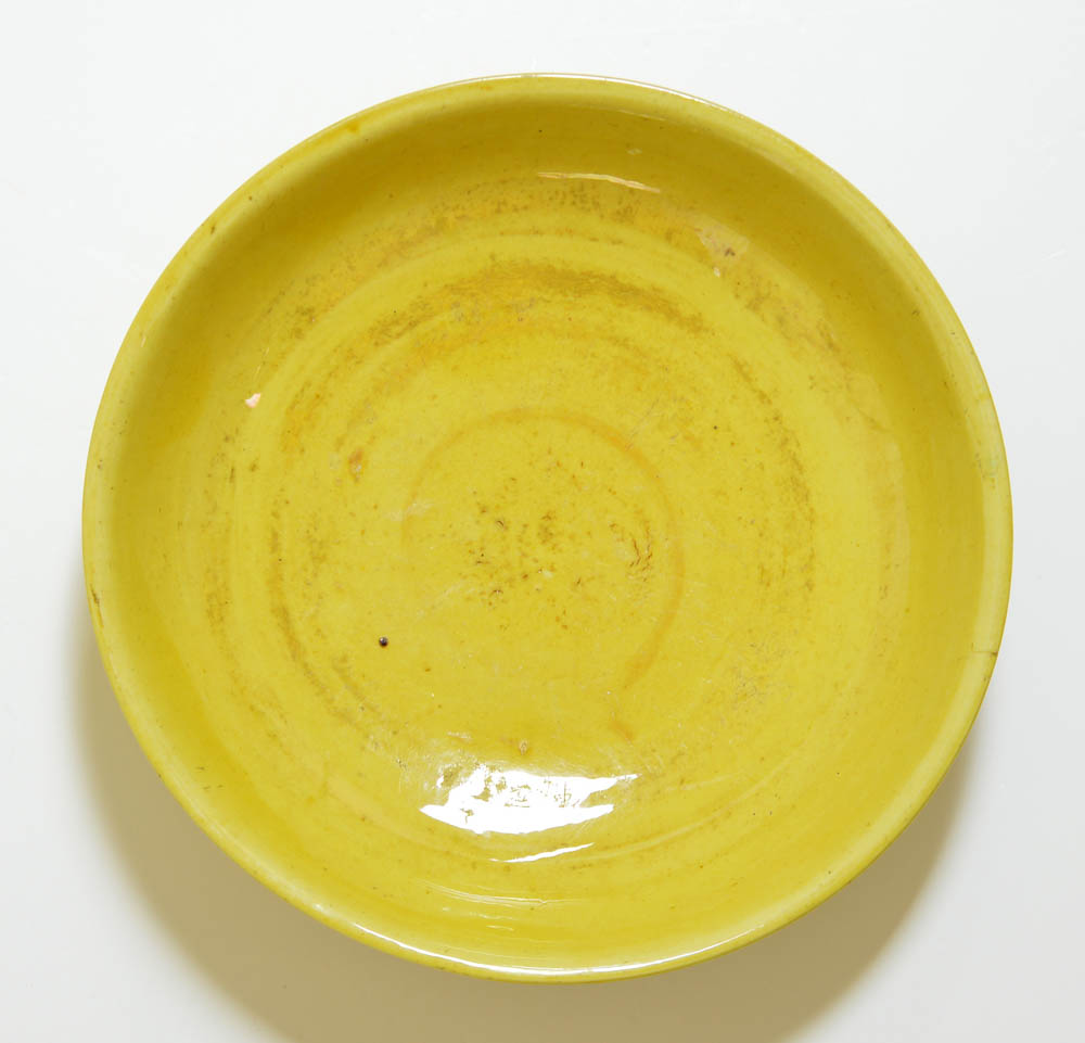 The porcelain dish covered with rich yellow enamel and crackles. Rare blue enamel incised mark on