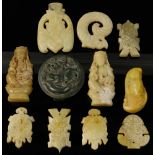 Group of eleven Chinese carved hardstone pendants.