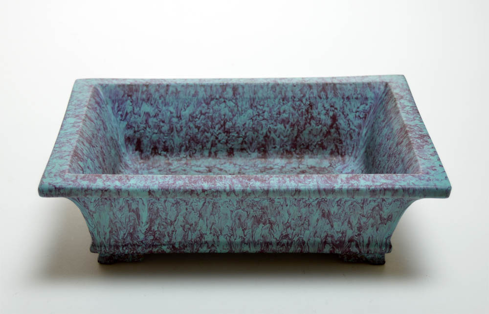 The planter covered overall and on the base with an opaque glaze of mottled turquoise and blue