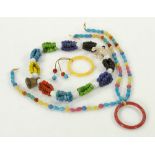 Lot of Asian jewelry, including two bangle bracelets and one multi-strand beaded necklace with bell,